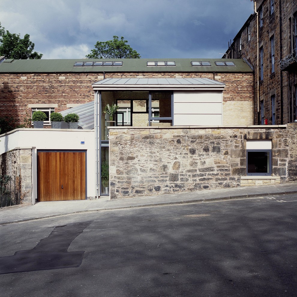 Design ideas for a contemporary two-storey exterior in Edinburgh with stone veneer.