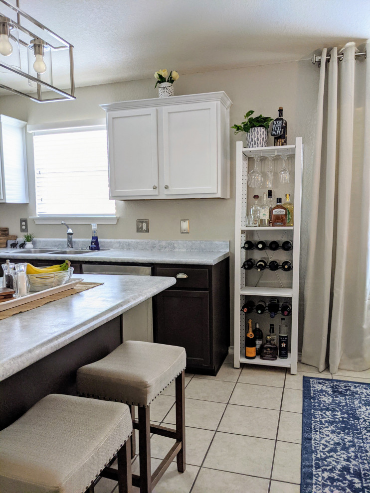 Inspiration for a mid-sized transitional l-shaped ceramic tile, beige floor and vaulted ceiling eat-in kitchen remodel in Austin with a double-bowl sink, raised-panel cabinets, light wood cabinets, laminate countertops, stainless steel appliances, an island and gray countertops