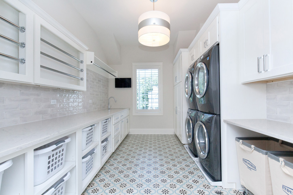 Photo of a modern galley laundry room in Chicago with white splashback, white walls and white benchtop.
