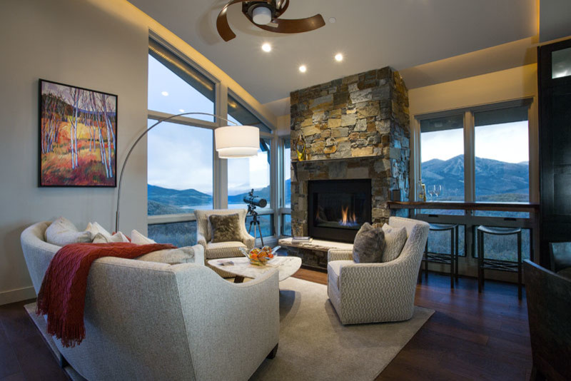 Photo of a mid-sized contemporary formal open concept living room in Salt Lake City with grey walls, a standard fireplace, a stone fireplace surround, dark hardwood floors, no tv and brown floor.