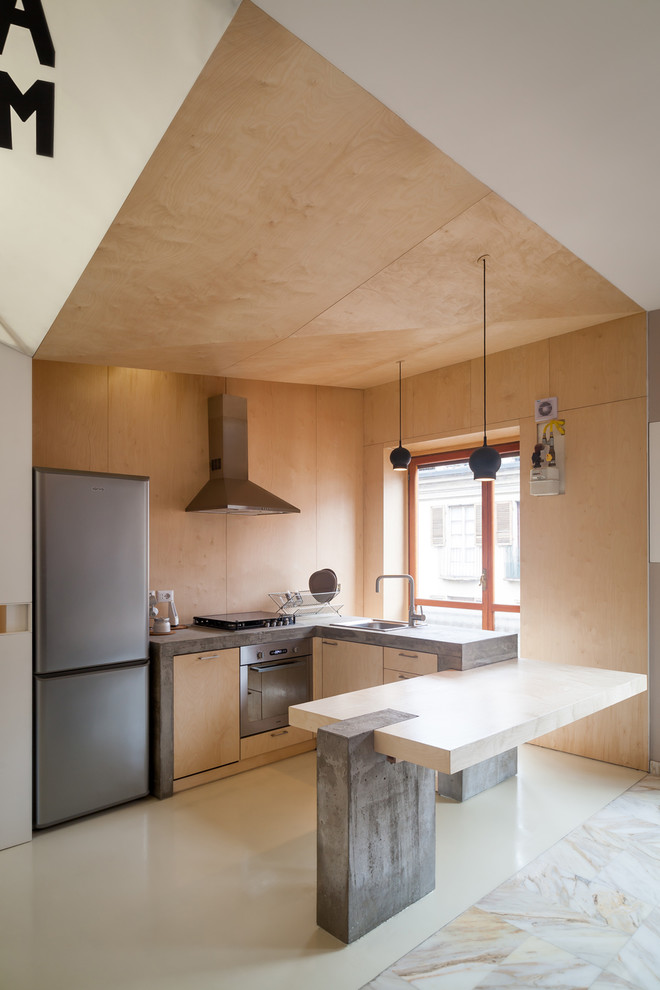 Design ideas for a small contemporary u-shaped open plan kitchen in Turin with a drop-in sink, flat-panel cabinets, light wood cabinets, wood benchtops, stainless steel appliances and porcelain floors.