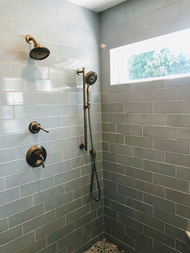 This is an example of a mid-sized transitional master bathroom in Baltimore with recessed-panel cabinets, white cabinets, a corner shower, a one-piece toilet, blue tile, subway tile, green walls, porcelain floors, an undermount sink, engineered quartz benchtops, grey floor, a hinged shower door, white benchtops, a shower seat, a double vanity and a freestanding vanity.