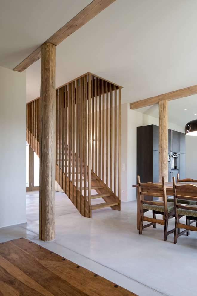 Design ideas for a mid-sized country wood straight staircase in Leipzig with wood risers.