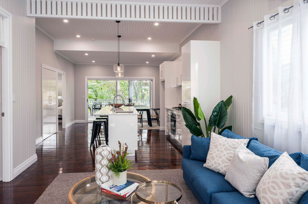 This is an example of a large contemporary formal open plan living room in Brisbane with white walls, dark hardwood flooring, a timber clad ceiling, panelled walls and tongue and groove walls.
