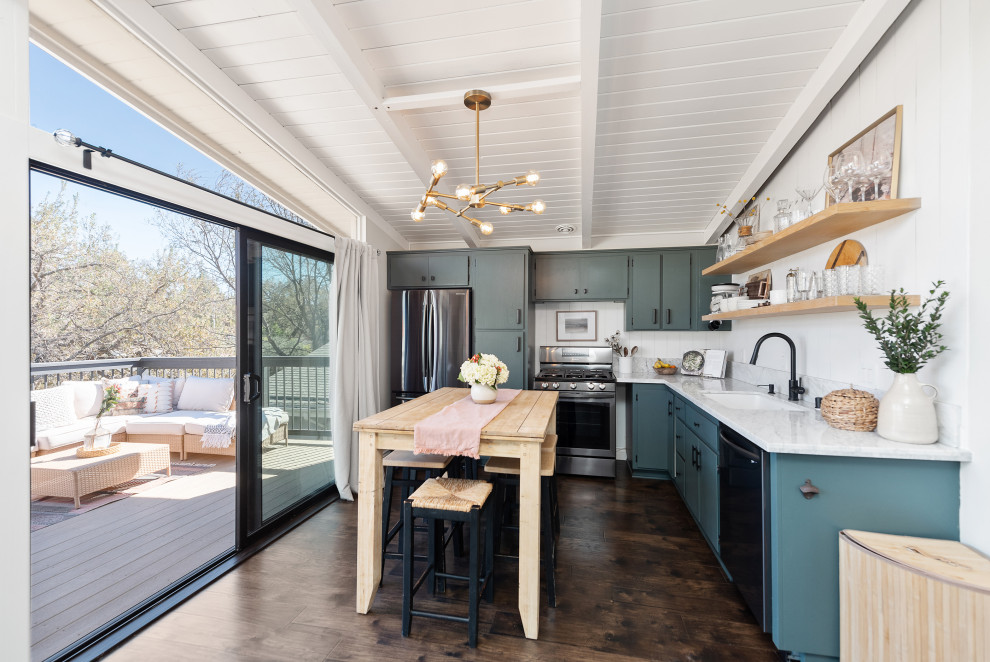 Small midcentury l-shaped open plan kitchen in Los Angeles with a drop-in sink, flat-panel cabinets, green cabinets, granite benchtops, white splashback, engineered quartz splashback, stainless steel appliances, medium hardwood floors, with island, brown floor, white benchtop and timber.