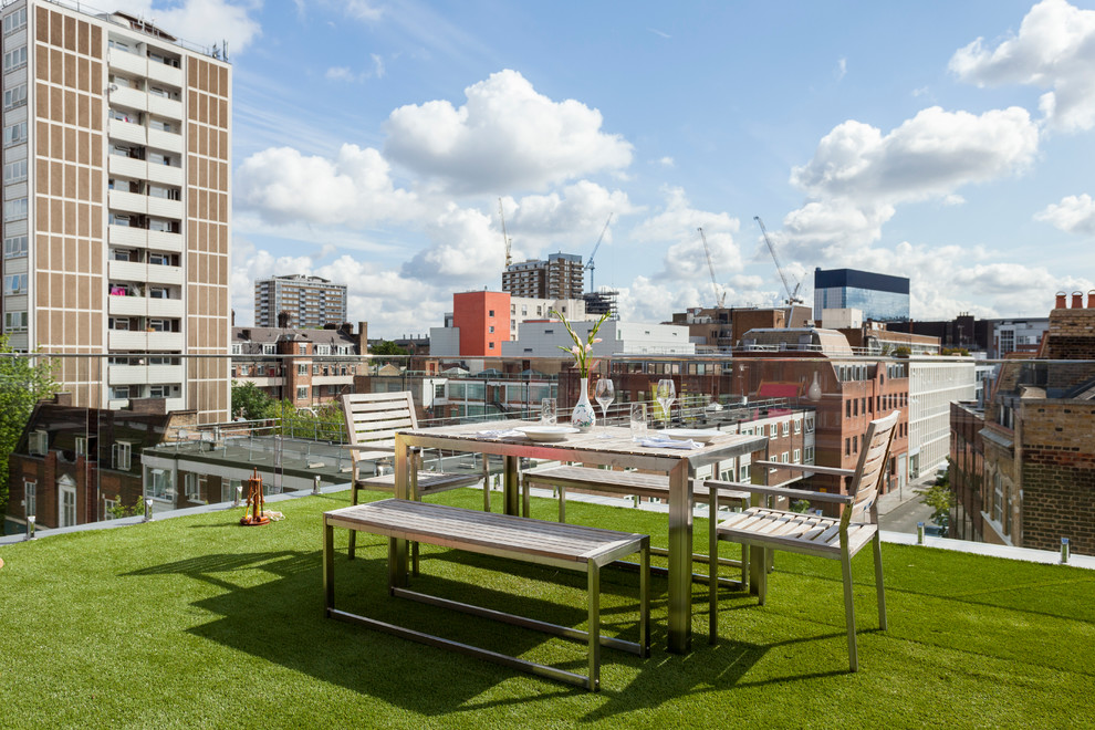 This is an example of a mid-sized contemporary rooftop and rooftop deck in London with no cover.