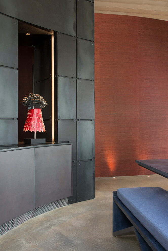 This is an example of a large contemporary hallway in Denver with concrete floors and red walls.