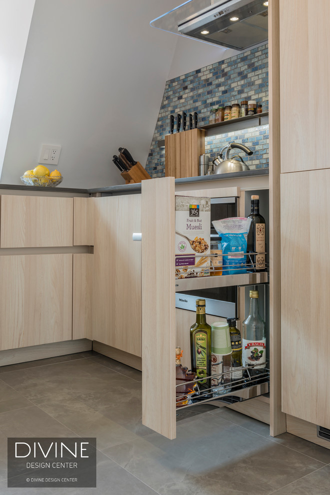 This is an example of a small contemporary u-shaped eat-in kitchen in Boston with an undermount sink, flat-panel cabinets, light wood cabinets, quartz benchtops, multi-coloured splashback, mosaic tile splashback, stainless steel appliances, slate floors, a peninsula and multi-coloured floor.
