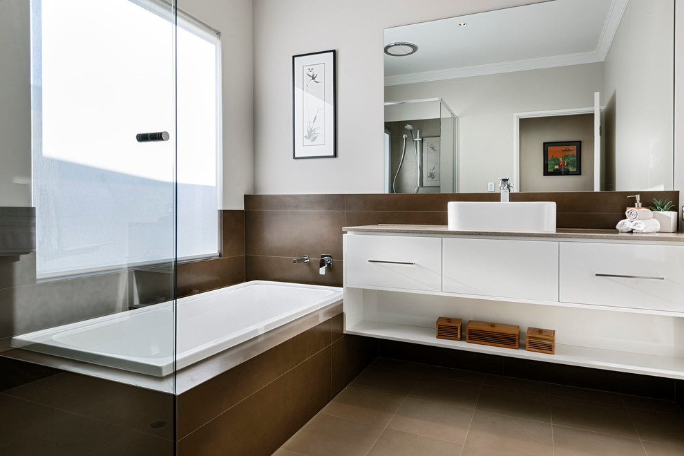 Photo of a mid-sized asian master bathroom in Perth with a vessel sink, flat-panel cabinets, white cabinets, a drop-in tub, brown tile, white walls and an alcove shower.