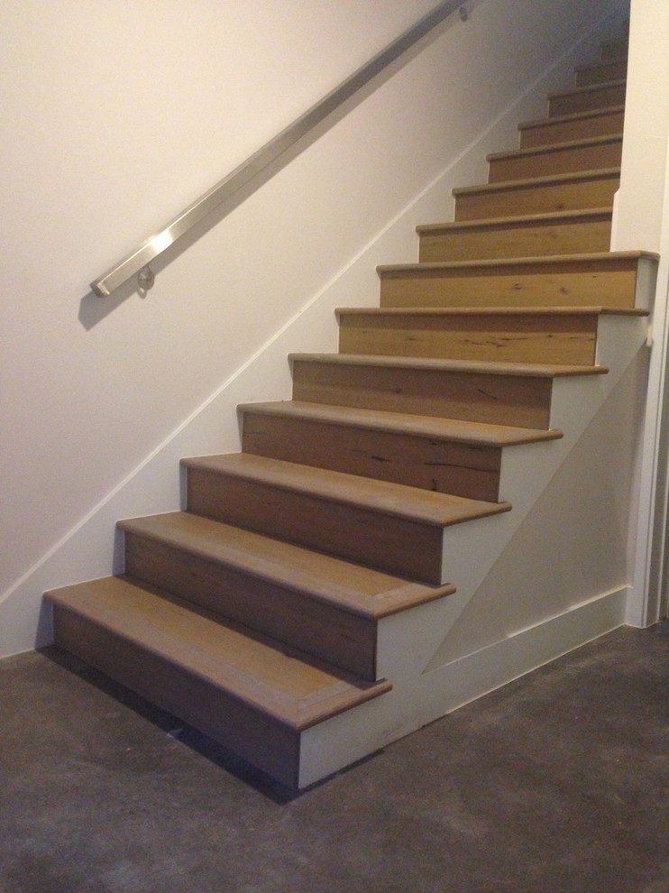 This is an example of a modern wood staircase in Austin with wood risers.