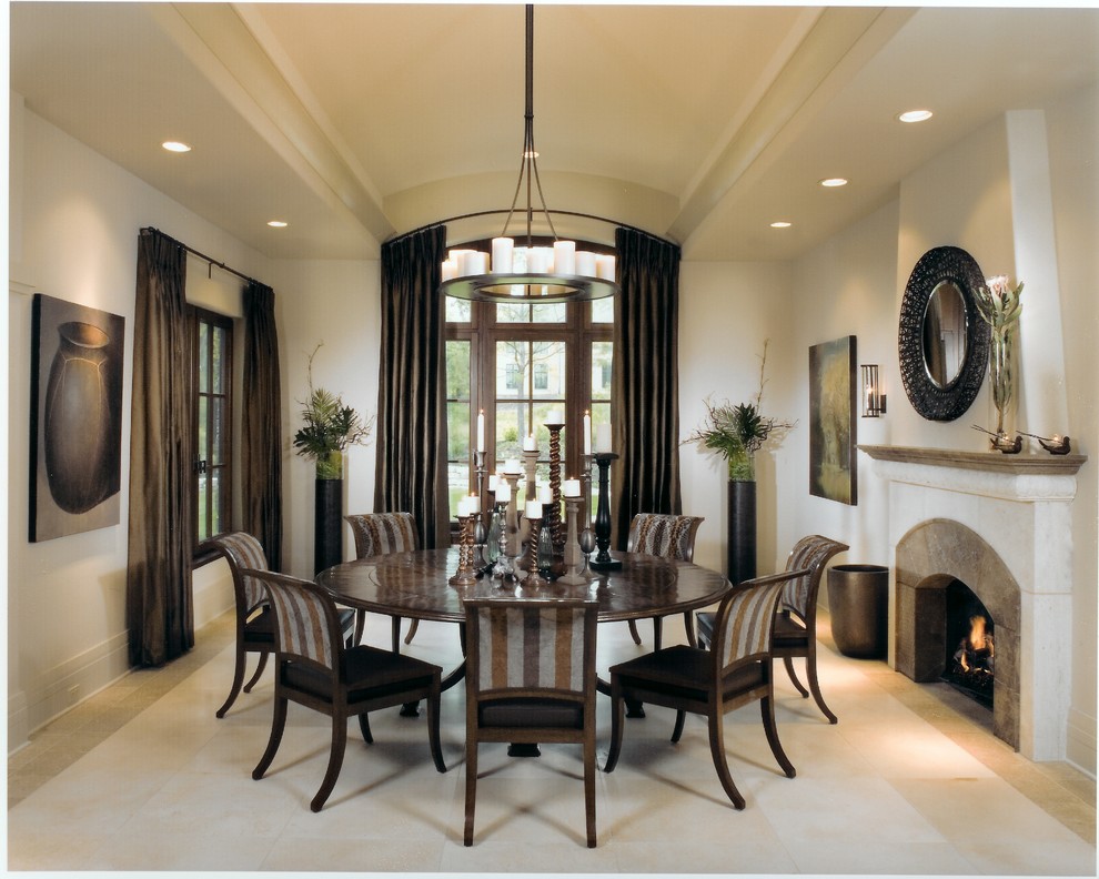 Large traditional separate dining room in Chicago with beige walls, a standard fireplace, limestone floors, a stone fireplace surround and beige floor.