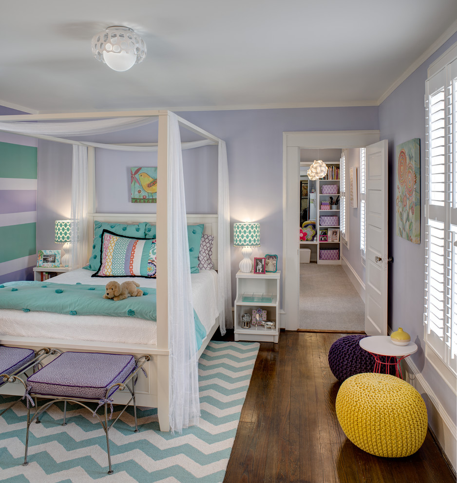 Photo of a traditional kids' bedroom for girls in Other with purple walls and dark hardwood floors.