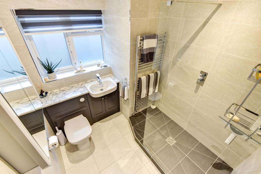 Photo of a small modern grey and white shower room bathroom in Sussex with shaker cabinets, grey cabinets, a walk-in shower, a two-piece toilet, grey tiles, ceramic tiles, grey walls, ceramic flooring, a built-in sink, laminate worktops, grey floors, white worktops, feature lighting, a single sink and a built in vanity unit.