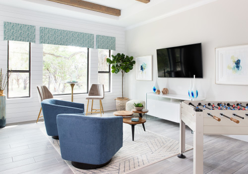  Green and blue foosball table in a living room with white walls, and the accent colours are green and blue.