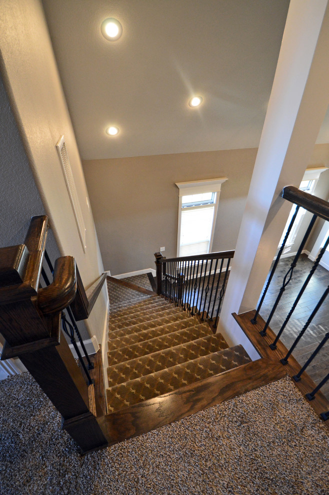 Design ideas for a transitional carpeted staircase in Other with wood risers.