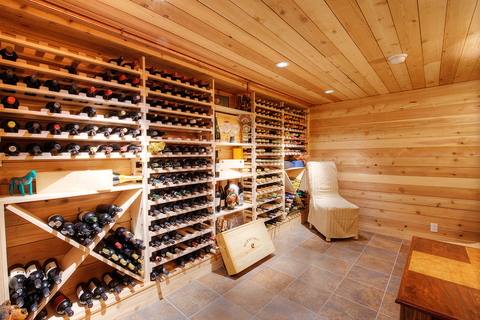 This is an example of a large contemporary wine cellar in San Francisco with ceramic floors and storage racks.