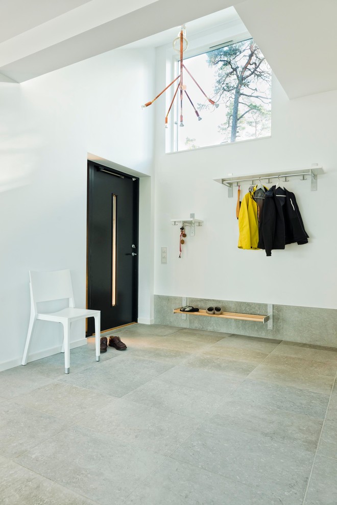 Photo of a mid-sized scandinavian entryway in Other with white walls and limestone floors.