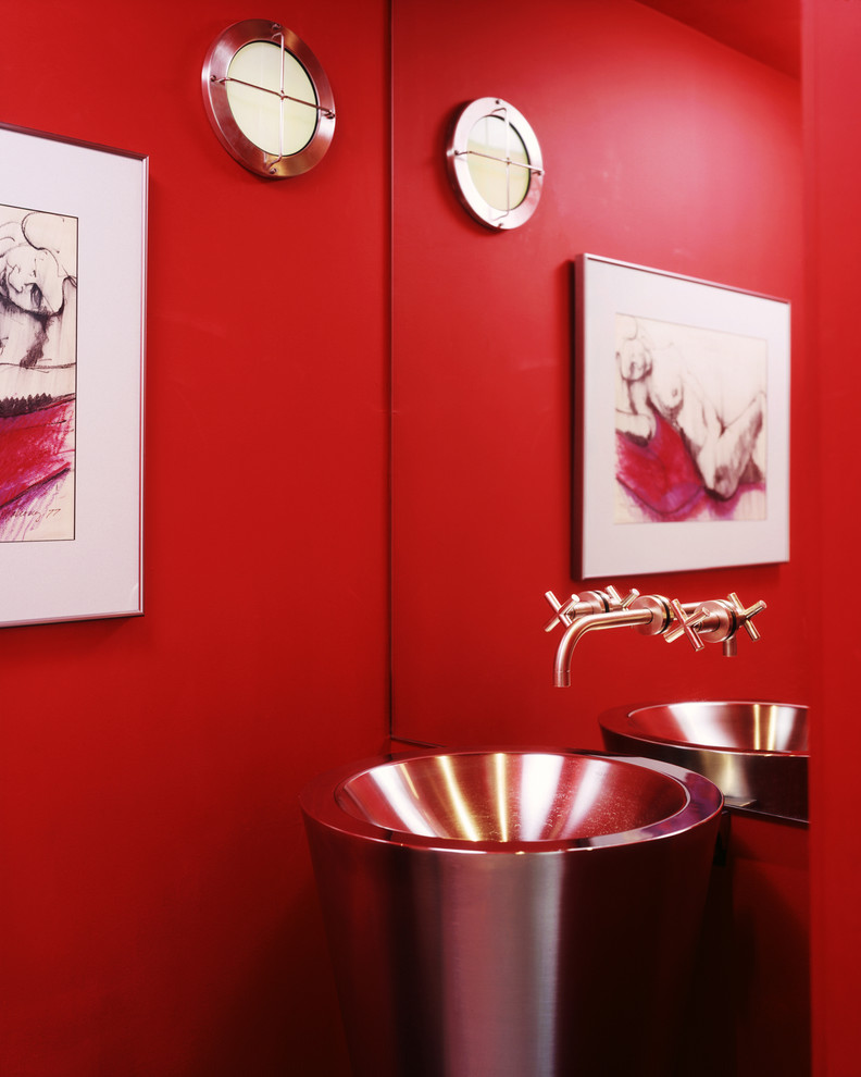 Design ideas for a contemporary powder room in Austin with a pedestal sink and red walls.