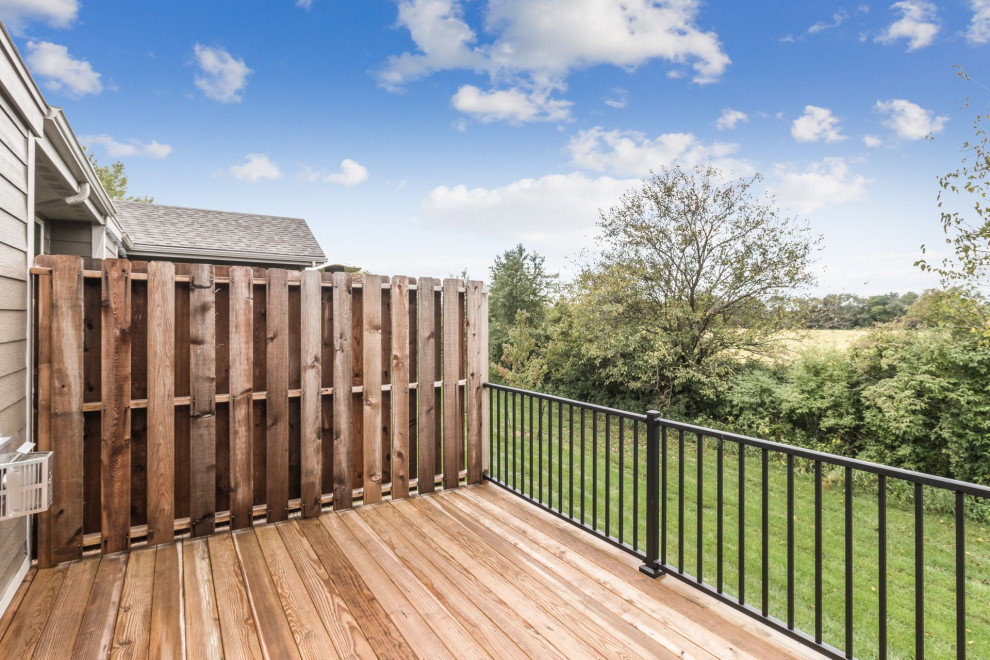 Inspiration for a small transitional backyard deck remodel with no cover