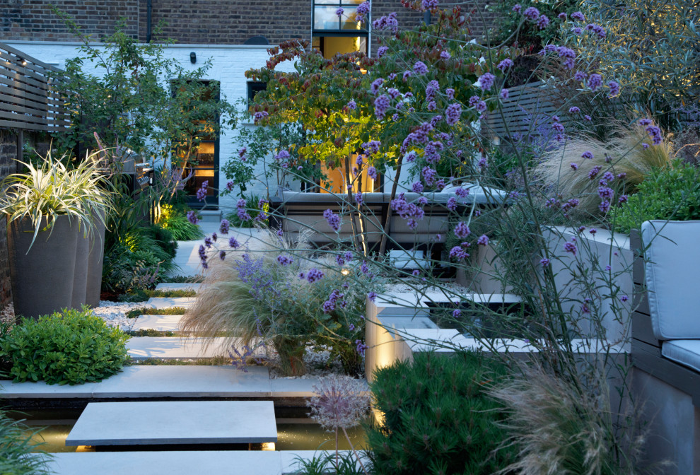 Design ideas for a small contemporary back raised pond in London.