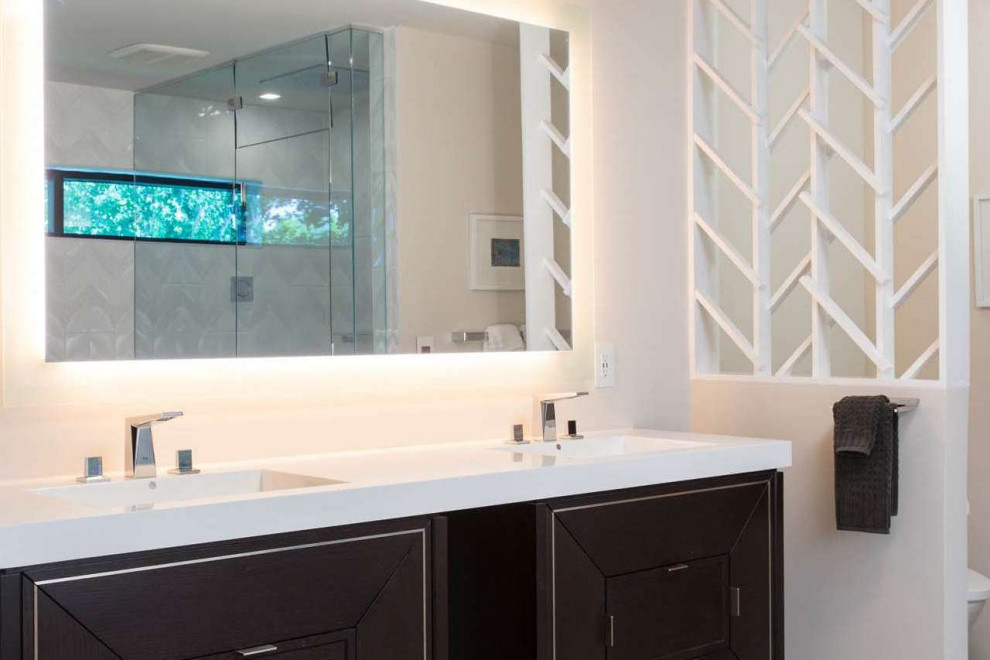 Photo of a mid-sized contemporary master bathroom in Kansas City with furniture-like cabinets, black cabinets, an open shower, white tile, ceramic tile, white walls, a drop-in sink, marble benchtops, a hinged shower door and white benchtops.
