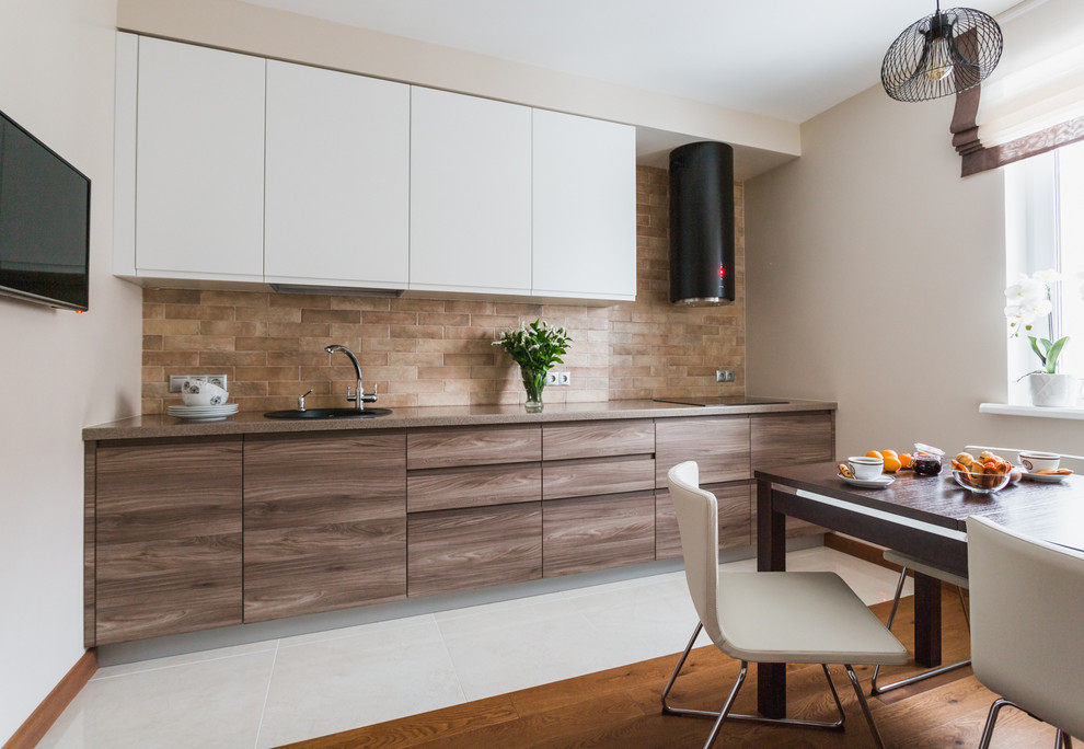 Inspiration for a mid-sized contemporary single-wall eat-in kitchen in Moscow with a drop-in sink, flat-panel cabinets, brown splashback, no island, medium wood cabinets, solid surface benchtops, porcelain splashback, black appliances and porcelain floors.