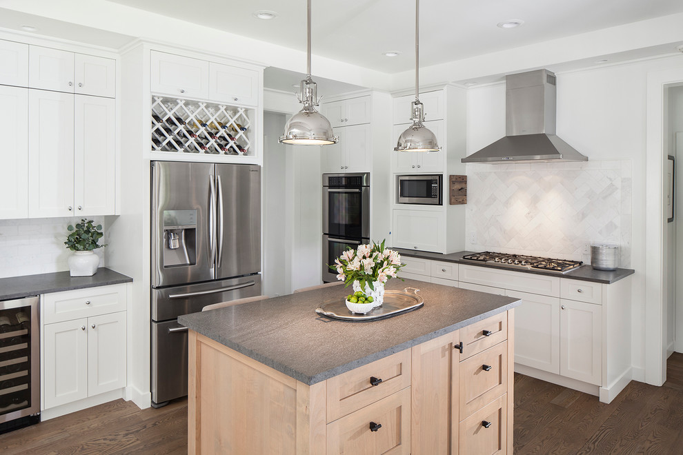 Design ideas for a traditional kitchen in Austin with shaker cabinets, white cabinets, soapstone benchtops, multi-coloured splashback, subway tile splashback, stainless steel appliances, medium hardwood floors and with island.