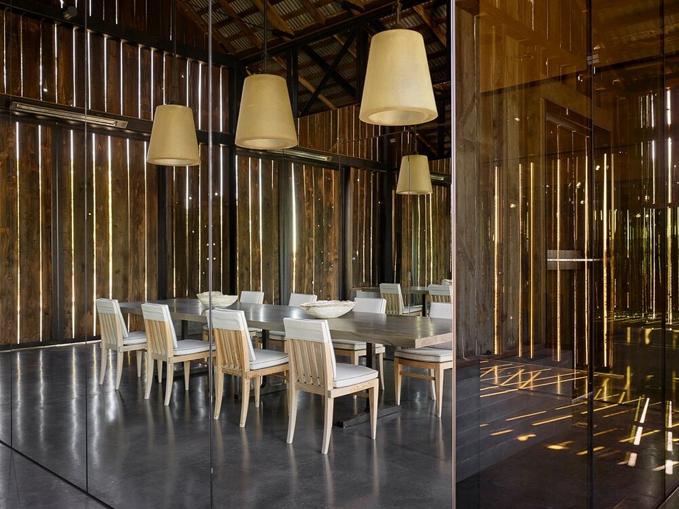 Inspiration for a large country separate dining room in San Francisco with metallic walls, concrete floors and no fireplace.