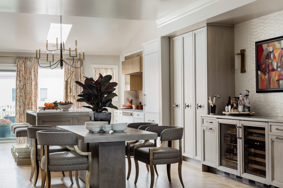 Eat-in kitchen - large transitional l-shaped light wood floor eat-in kitchen idea in Boston with paneled appliances, an island and white cabinets