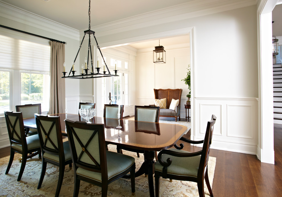 Mid-sized transitional separate dining room in New York with beige walls and dark hardwood floors.