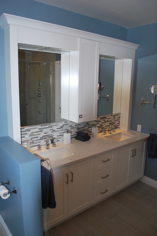 Example of a mid-sized transitional master blue tile, green tile, multicolored tile and matchstick tile porcelain tile bathroom design in Ottawa with shaker cabinets, white cabinets, blue walls, an undermount sink and quartz countertops