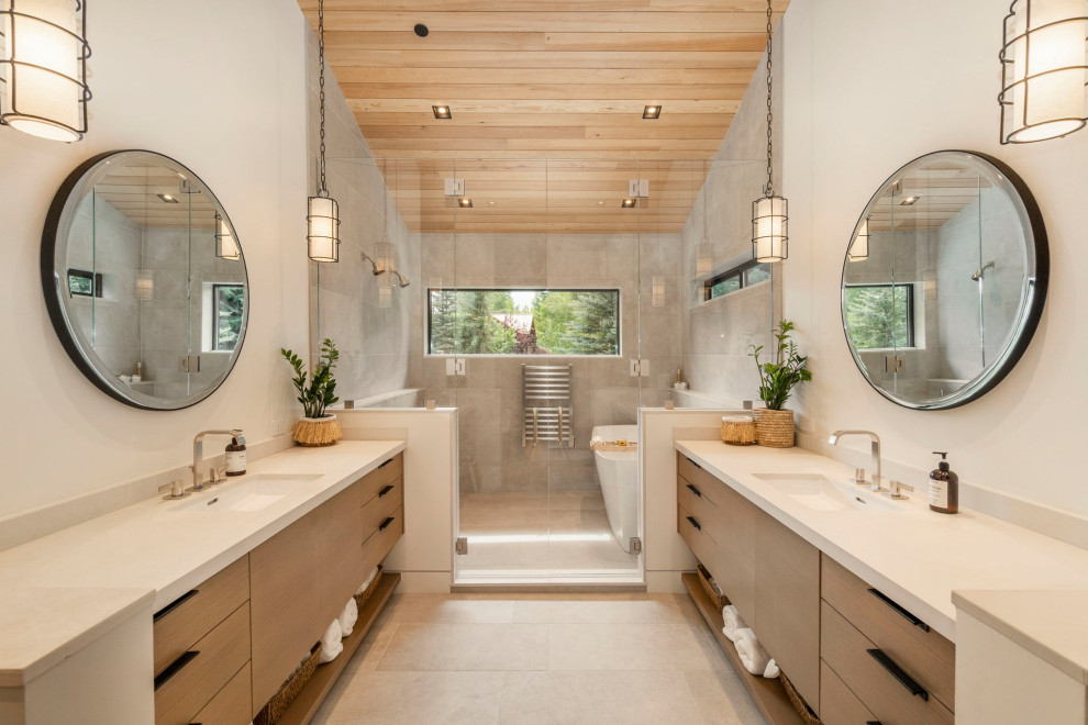 Example of a huge trendy master beige tile and ceramic tile ceramic tile, beige floor, double-sink, vaulted ceiling and wood ceiling bathroom design in Other with flat-panel cabinets, a two-piece toilet, beige walls, an undermount sink, quartz countertops, a hinged shower door, beige countertops, a built-in vanity and medium tone wood cabinets