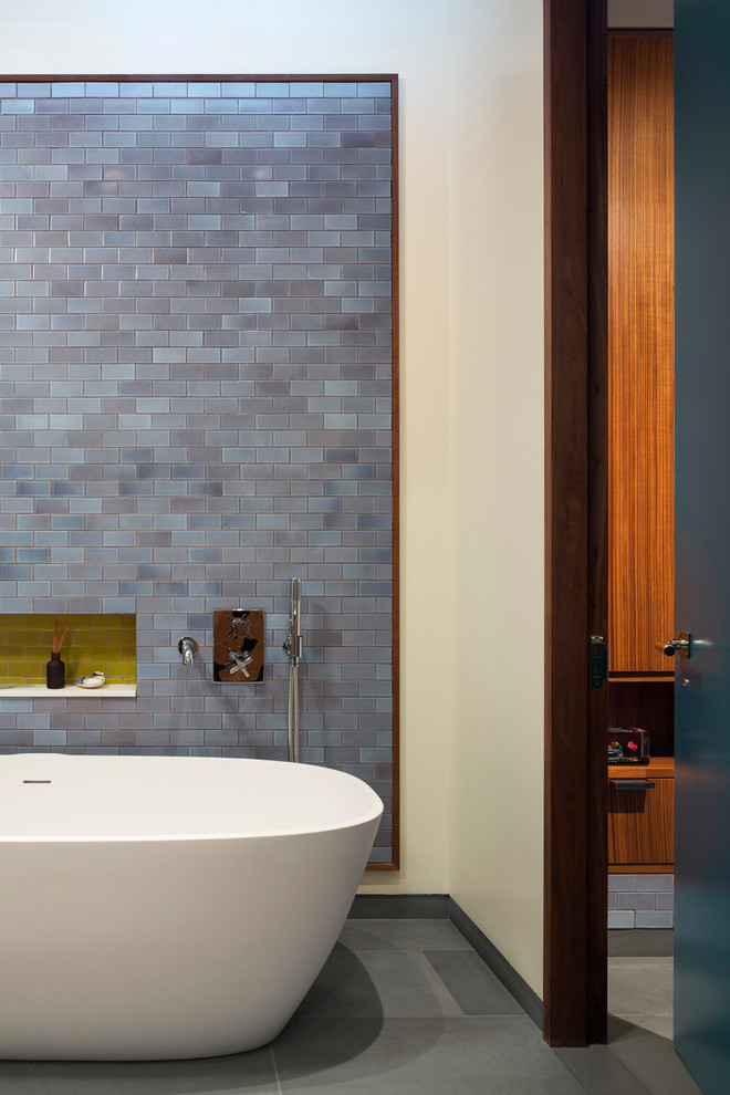Design ideas for an industrial master bathroom in New York with multi-coloured tile and ceramic tile.