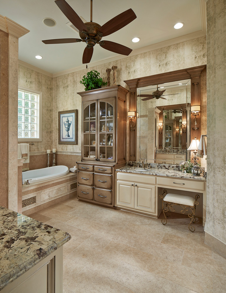 Inspiration for a large traditional master bathroom in Dallas with an undermount sink, raised-panel cabinets, white cabinets, granite benchtops, a drop-in tub, an open shower, a two-piece toilet, stone tile, multi-coloured walls and limestone floors.
