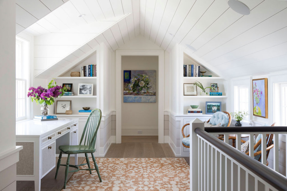 Photo of a beach style home office in Boston with white walls, medium hardwood floors, a freestanding desk and brown floor.