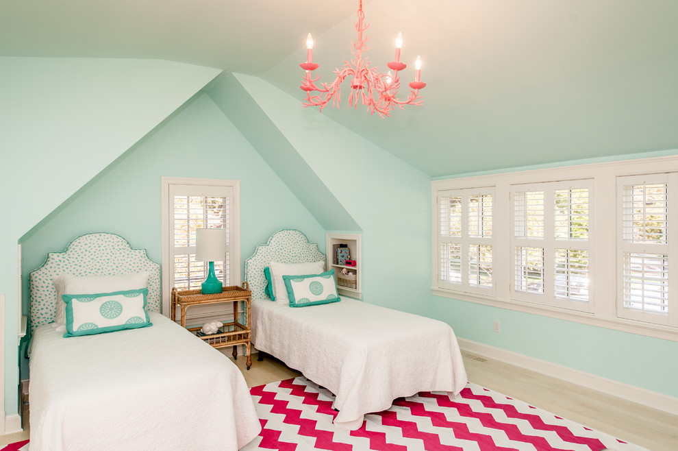 This is an example of a mid-sized traditional kids' bedroom for kids 4-10 years old and girls in DC Metro with light hardwood floors and blue walls.