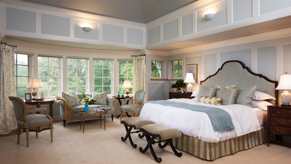 Photo of a large traditional master bedroom in Boston with blue walls, carpet, no fireplace and beige floor.