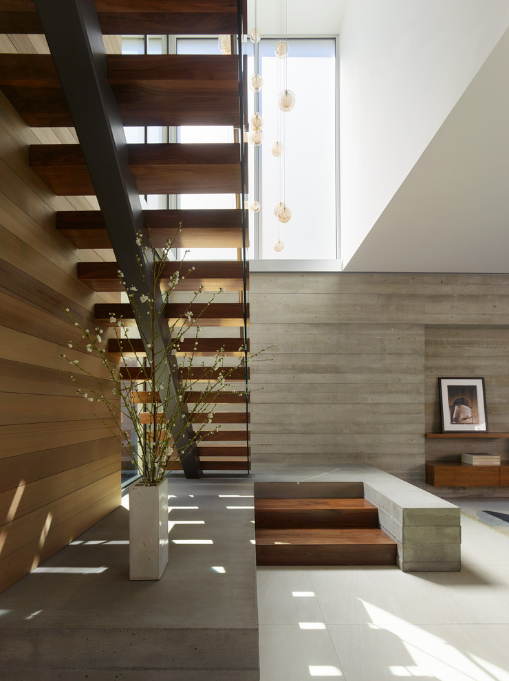 Photo of a contemporary wood u-shaped staircase in Los Angeles with open risers.