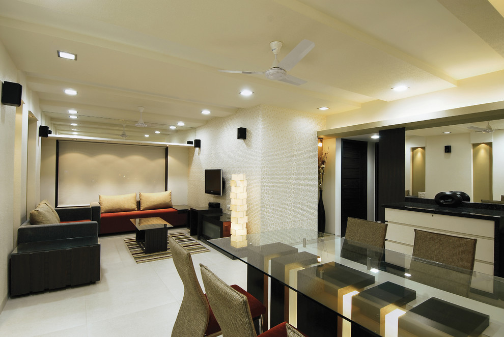 This is an example of a large contemporary open concept living room in Mumbai with beige walls and porcelain floors.