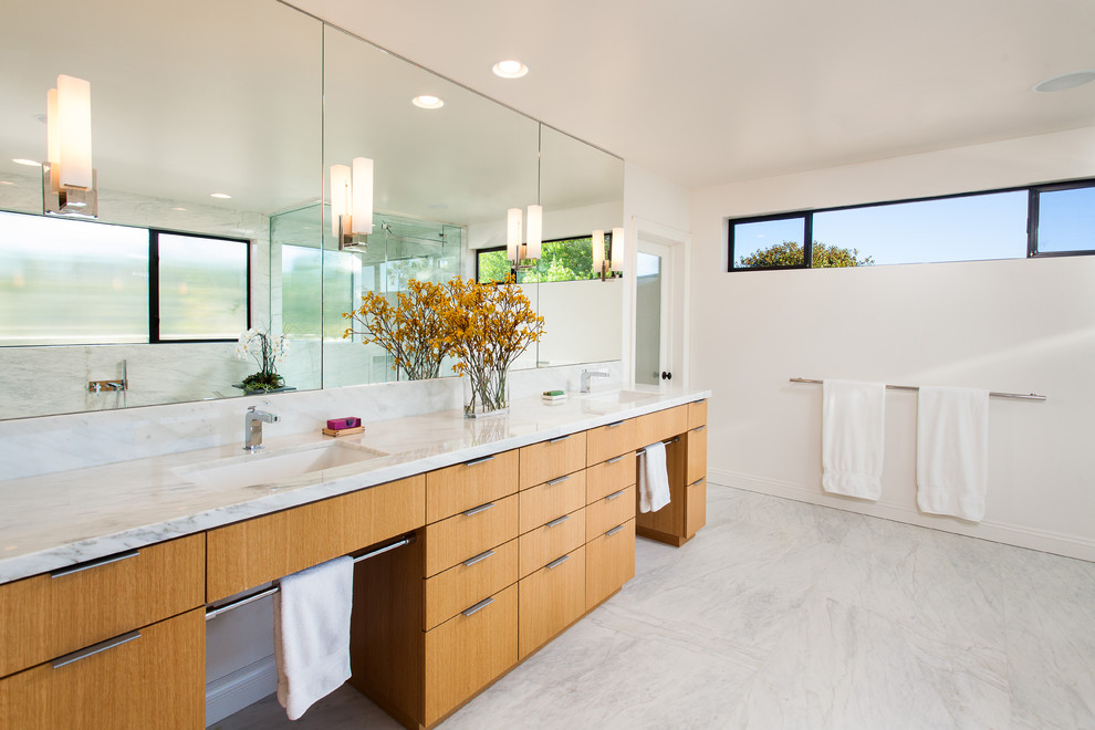 Design ideas for a large contemporary master bathroom in Los Angeles with an undermount sink, flat-panel cabinets, light wood cabinets, white tile, an undermount tub, a corner shower, a two-piece toilet, marble, white walls, marble floors, marble benchtops, white floor and a hinged shower door.
