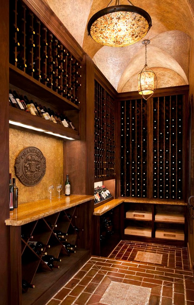 Mid-sized mediterranean wine cellar in Dallas with brick floors and storage racks.
