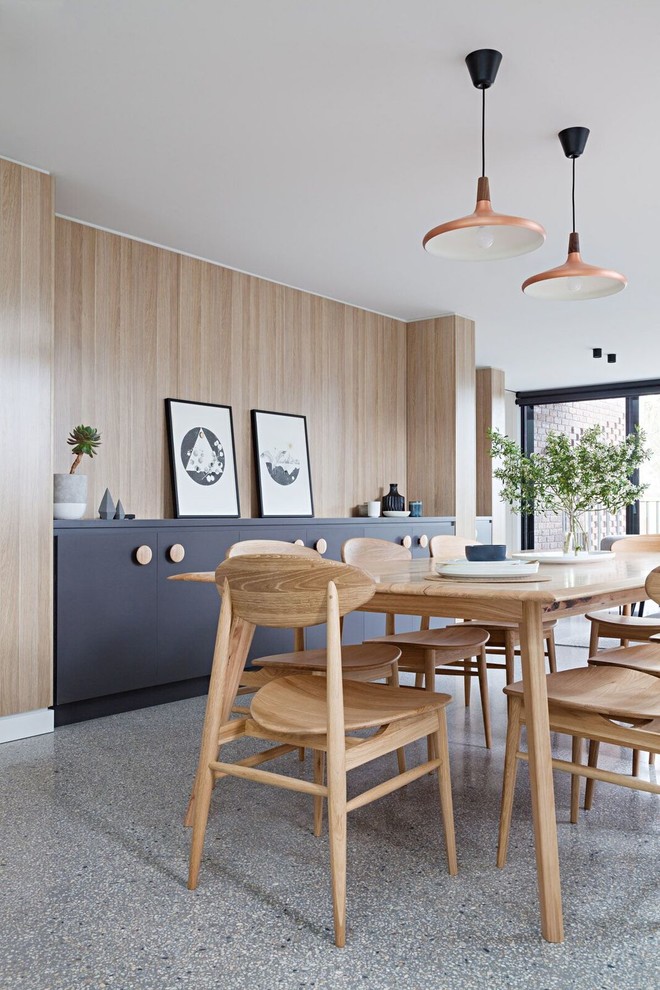This is an example of a mid-sized contemporary dining room in Melbourne with concrete floors and beige walls.