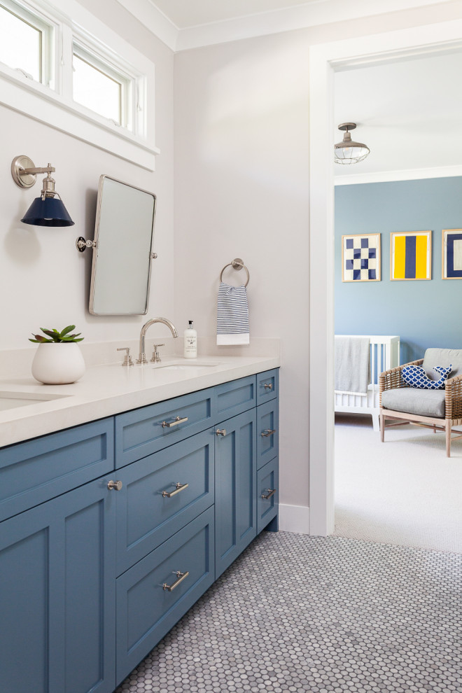 Mid-sized beach style toddler room in Orange County with grey walls, marble floors and grey floor for boys.