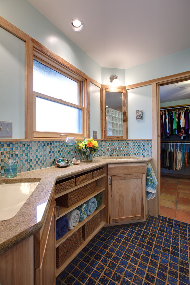 This is an example of a mid-sized master bathroom in Austin with flat-panel cabinets, light wood cabinets, blue tile, glass tile, blue walls, ceramic floors, an undermount sink, granite benchtops, blue floor, an open shower and beige benchtops.
