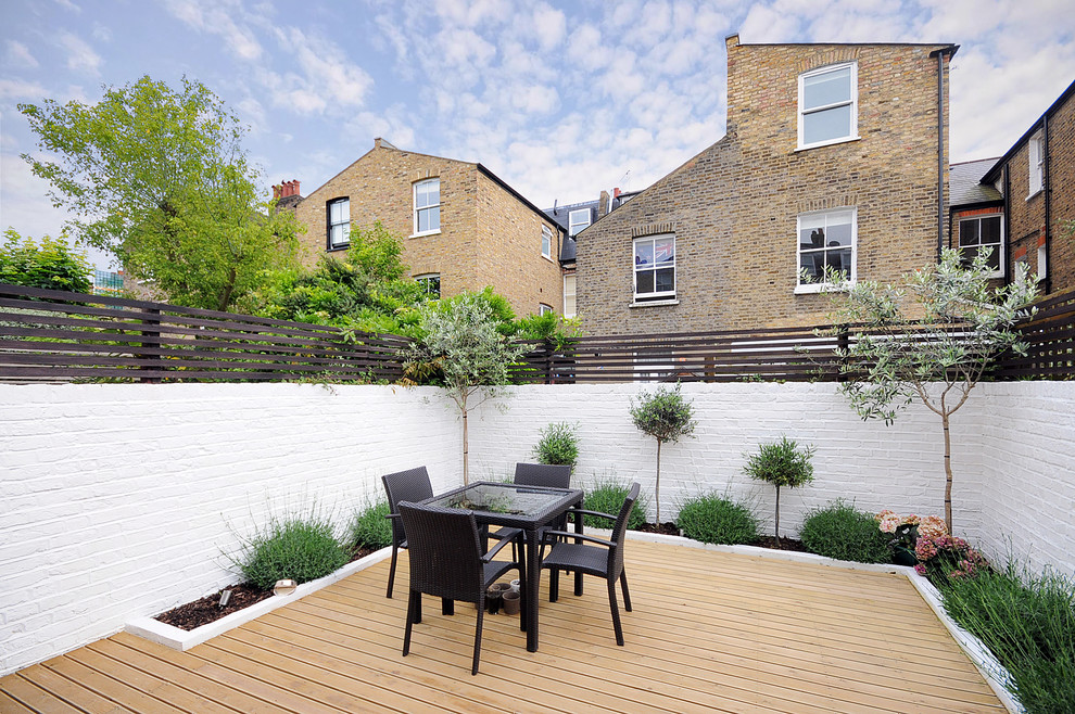 Contemporary patio in London with decking and no cover.