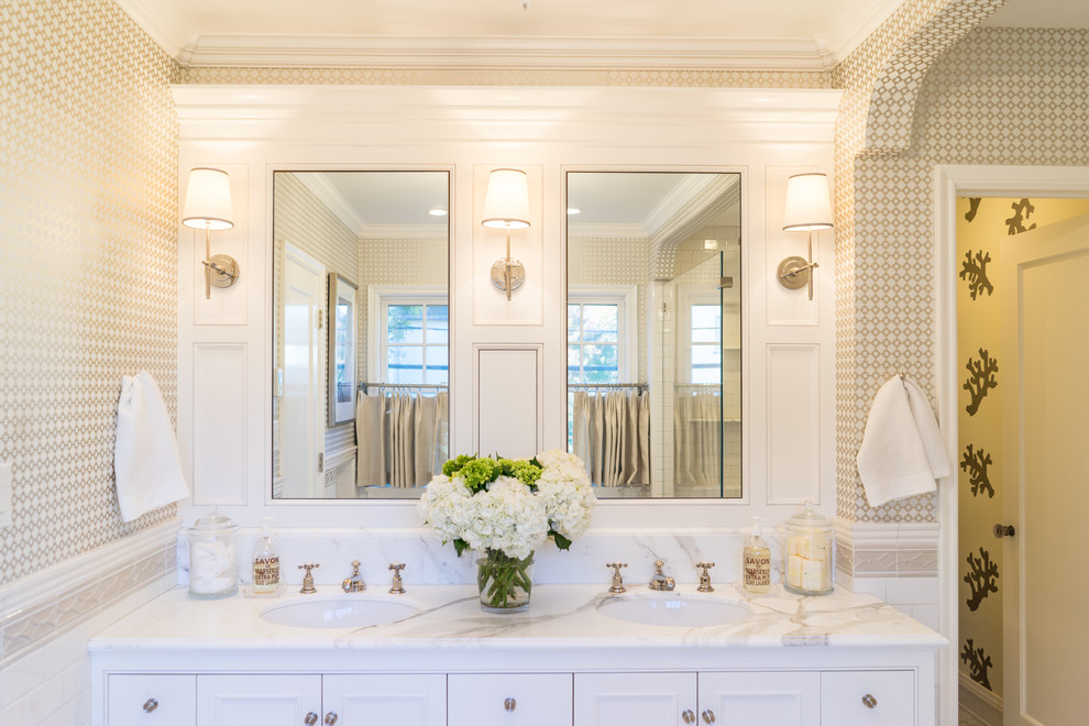 Design ideas for a large mediterranean master bathroom in San Francisco with white cabinets, an undermount tub, a corner shower, an undermount sink, a hinged shower door, furniture-like cabinets, multi-coloured walls and marble benchtops.