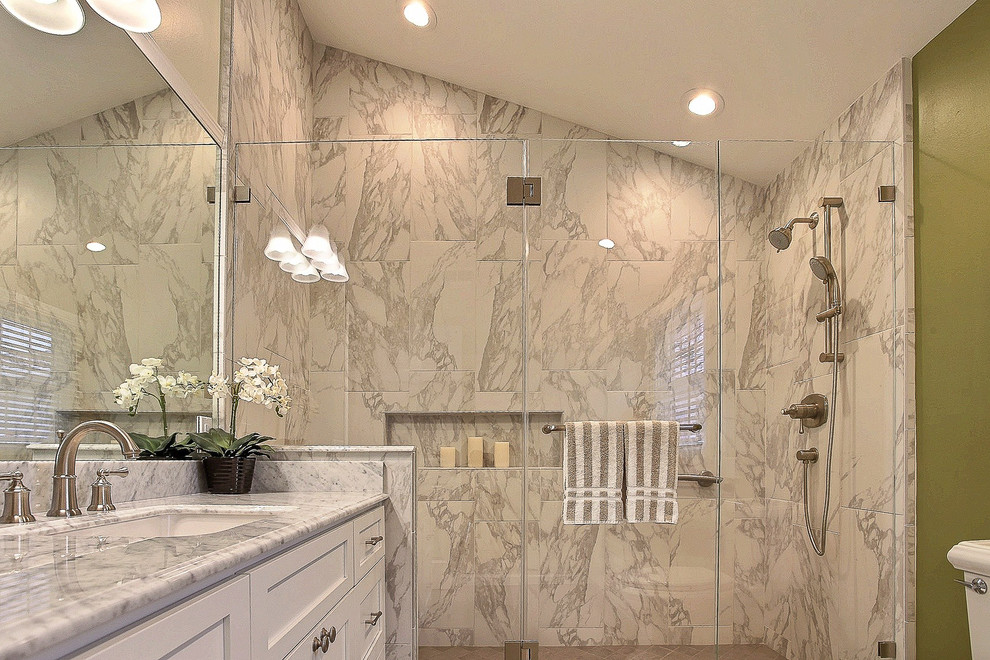 This is an example of a mid-sized transitional master bathroom in San Francisco with an undermount sink, recessed-panel cabinets, white cabinets, a double shower, a one-piece toilet, brown tile, green walls and ceramic floors.