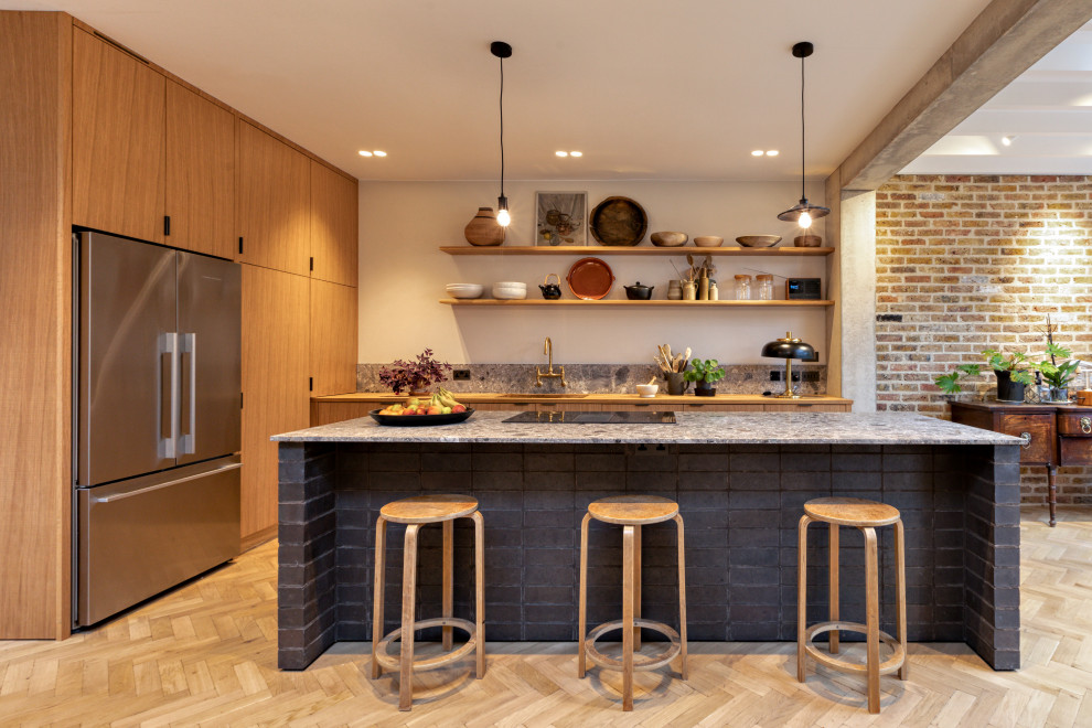 Photo of a large contemporary l-shaped eat-in kitchen in London with a double-bowl sink, flat-panel cabinets, black cabinets, wood benchtops, grey splashback, marble splashback, panelled appliances, plywood floors, with island, beige floor, white benchtop and exposed beam.