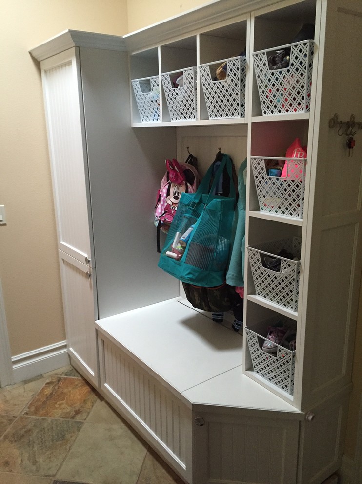 Inspiration for a mid-sized contemporary mudroom in Tampa with beige walls and slate floors.