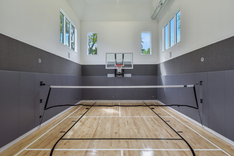 Large eclectic indoor sport court in Chicago with white walls and light hardwood floors.